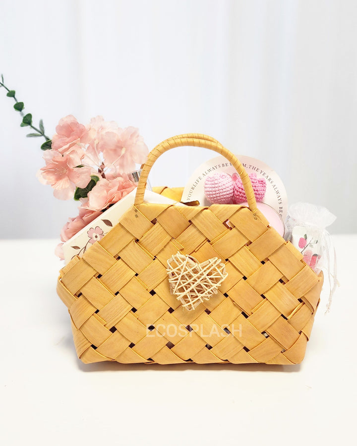 Yellow woven handbag with a heart design on a white background